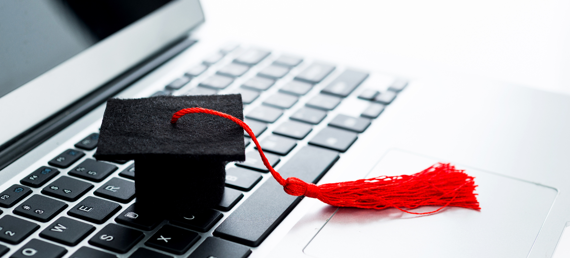 Graduation hat on computer keyboard